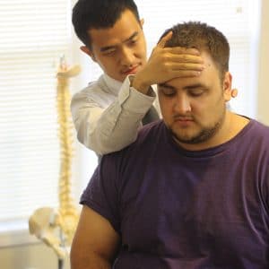 Chiropractor Lawrenceville GA Hung Vuong adjusting patient